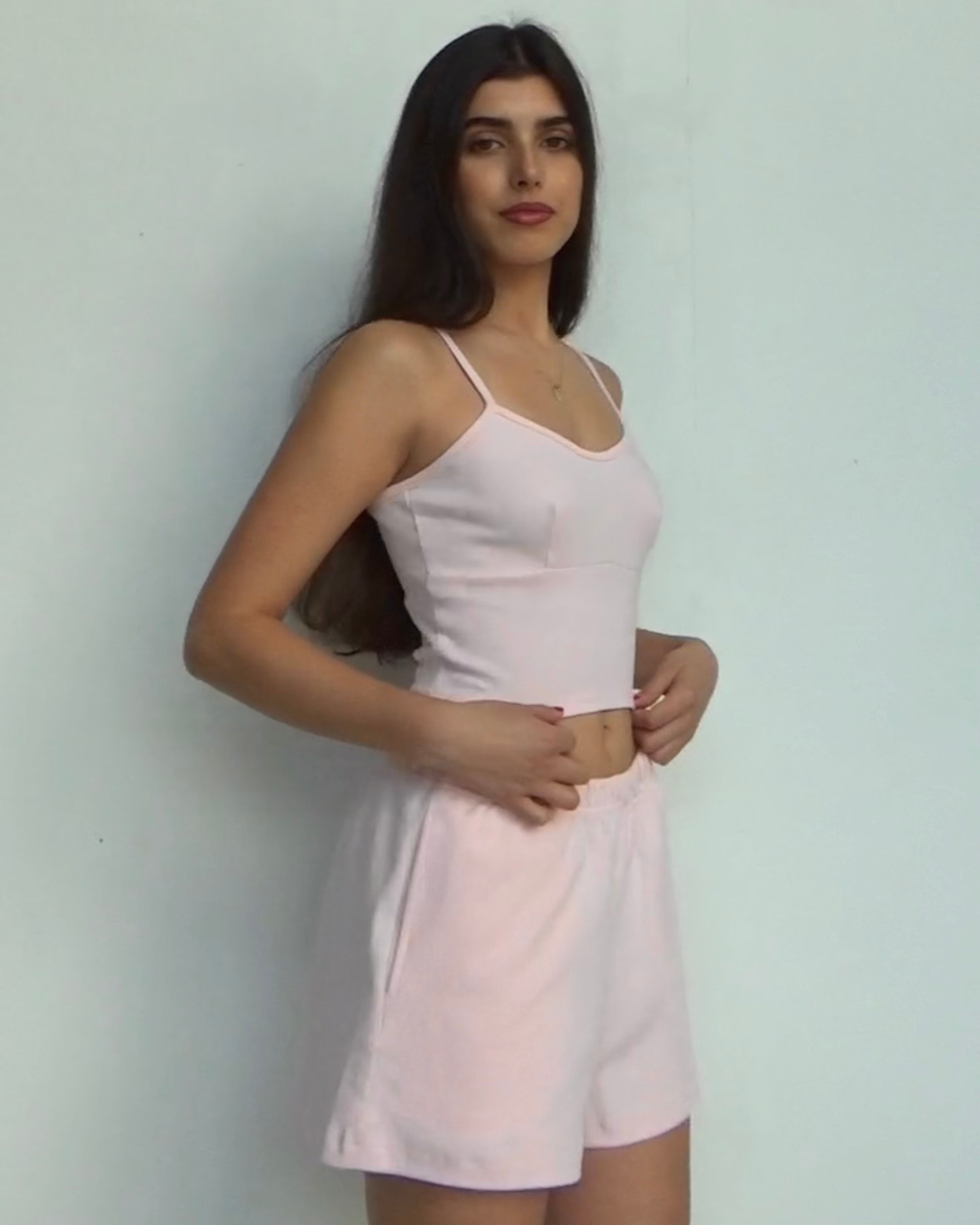 organic cotton pajama shorts in blush, ¾-front view with elastic waistband and side pockets